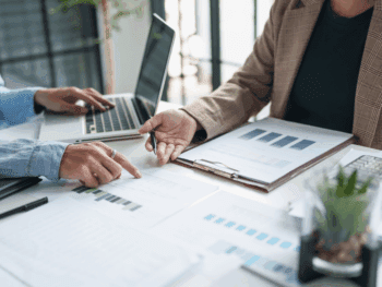 business people looking over internal theft reports